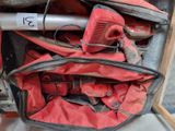 a red bag filled with tools and a blow dryer