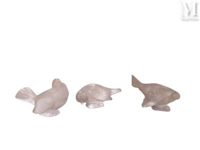 three figurines of birds sitting next to each other
