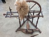 a spinning wheel with a wig on top of it