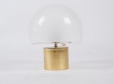 a white and gold table lamp with a glass dome on a gold base