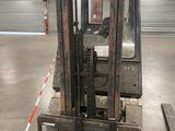 a forklift in a warehouse with a red line on the floor