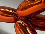 an orange balloon shaped like a dog sitting on a table