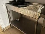 a kitchen with a sink and a counter with a towel on it