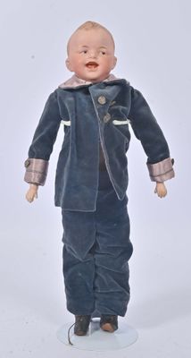 a small doll that is standing on a white surface