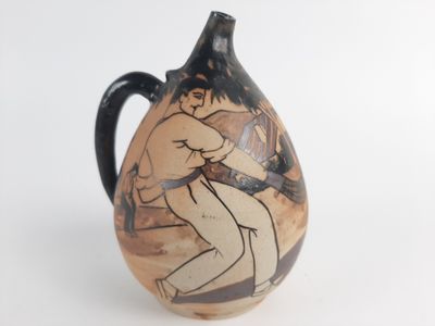 a vase with a picture of a man wrestling a woman