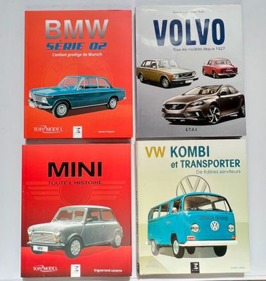 four books on a white table with a blue vw bus and a red vw bus