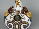 a white vase with a blue and gold decoration on it
