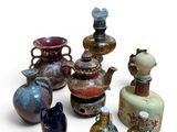 many different vases that are sitting on a white surface