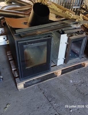 a stove sitting on top of a pallet in a garage