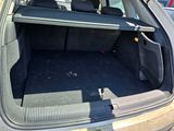 the back of a car with its trunk open and the seat folded down