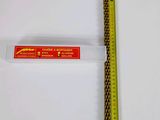 a close up of a ruler on a white surface next to a ruler