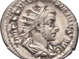 a silver coin with an image of a man wearing a crown on it
