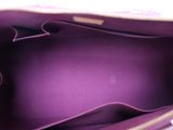 the inside of a purple purse with a zipper on the inside