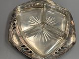 an antique silver plate with a starburst design on it
