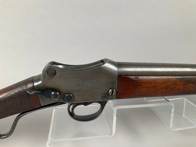 a rifle with a wooden barrel and a metal handle