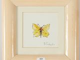 a picture of a picture of a yellow butterfly in a wooden frame
