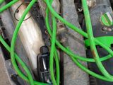 a green hose attached to a black and white machine