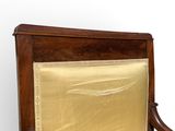 an image of a wooden chair with a gold cloth on it