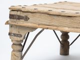 a small wooden bench made out of wood and metal