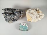 three different types of rocks on a table with a white background