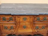 a marble top dresser with a marble top on top of it