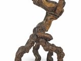 an image of a sculpture of a tree trunk with a bird perched on top of it