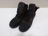 the pair of black boots are on a white surface