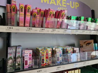 a lot of makeup products on the shelves in the store