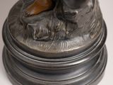 a bronze statue of a man with a dog on a pedestal