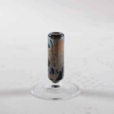 a small glass vase sitting on top of a glass stand