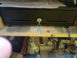 a black box with a key on it sitting on a shelf