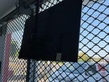 a flat screen tv mounted on the side of a building