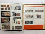 an open book with stamps on it on a table