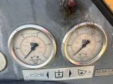 three gauges on the side of a metal panel