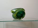 a glass vase sitting on top of a glass shelf