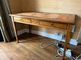 a wooden desk with two drawers on top of it