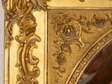 a picture of a mirror with a gold frame on it