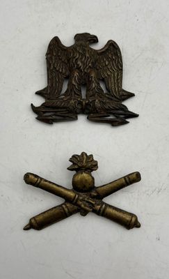 three metal badges of two eagle and two crossed swords
