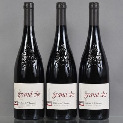 three bottles of red wine sitting on a table next to each other