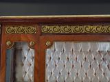 a cabinet with a glass door and a gold trimming
