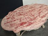 a table with a red paint on it in a room