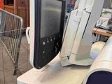 a computer monitor sitting on top of a desk in a room
