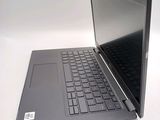 a laptop that is open on a white table