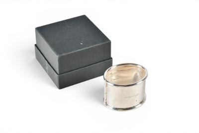 an image of a silver candle sitting next to a black box