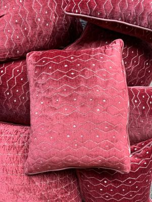 pillows piled on top of each other in a pile