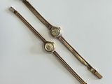 a pair of ladies ' s wrist watches on a white surface