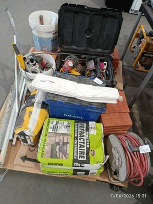 a cart full of tools on the floor in the garage