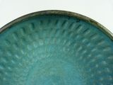 a close up of a blue plate with a circular design