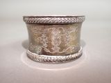 a silver ring with a design on it on a table