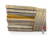 many books stacked on top of each other on a table
